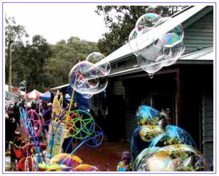 blowing gant bubbles at a market